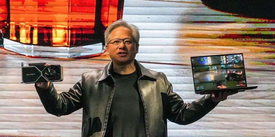 Nvidia president and CEO Jensen Huang holds a graphics card NVIDIA 4060Ti and a laptop at a keynote presentation at Computex, or the Taipei International Information Technology Show, on May 29, 2023.