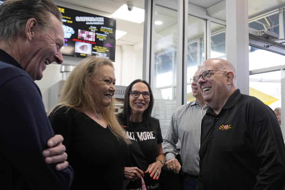 Former Maryland Gov. Larry Hogan, right, talks with patrons of DePaola's Bagel and Brunch in Stevensville, Md., Friday, April 12, 2024, as he campaigns for the U.S. Senate. (AP Photo/Susan Walsh)