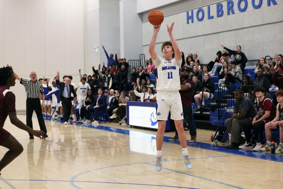 Holbrook's Owen Burke drains a 3-pointer for his 1,000th career point during a game against South Shore Christian Academy on Friday, Jan. 13, 2023.