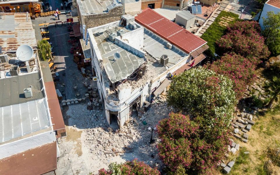 A partially destroyed building in Kos is seen from above - Credit: Nikiforos Pittaras/AP