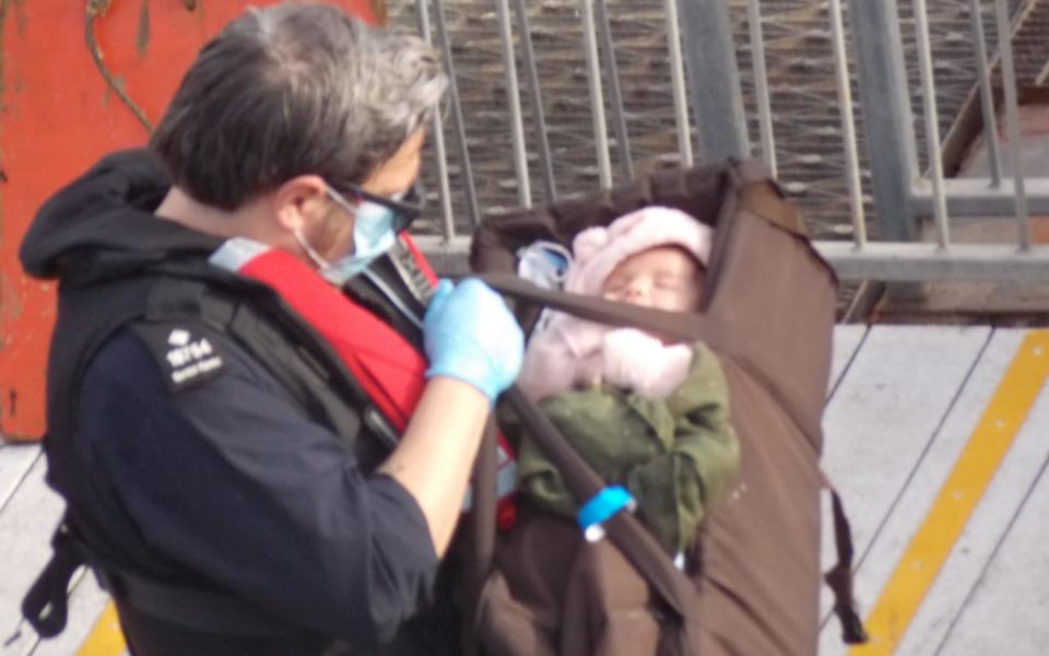 A tiny baby was among those who arrived in Dover yesterday after crossing the channel on a dinghy - Steve Laws/SWNS