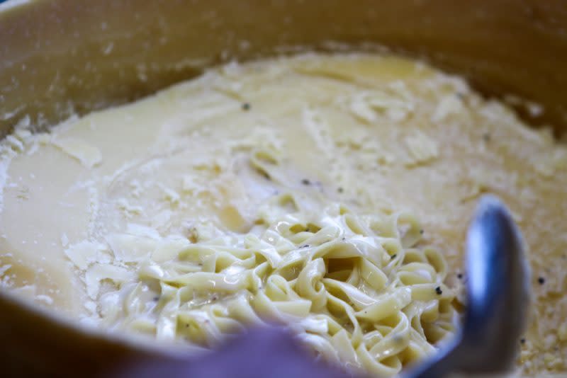 Close up of pasta in cheese wheel