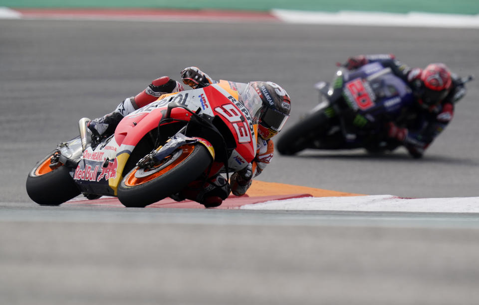 Spain's Marc Marquez (93) steers through a turn ahead of Fabio Quartararo (20), of France, during the MotoGP Grand Prix of the Americas motorcycle race at Circuit of the Americas, Sunday, Oct. 3, 2021, in Austin, Texas. (AP Photo/Eric Gay)