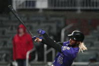 Colorado Rockies pinch-hitter Raimel Tapia drives in the go-ahead run with a base hit in the 10th inning of the team's baseball game against the Atlanta Braves on Wednesday, Sept. 15, 2021, in Atlanta. (AP Photo/John Bazemore)