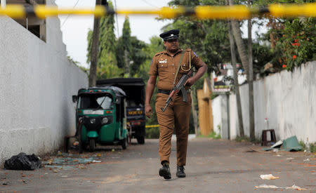 A Sri Lankan police officer walks near the motel, where the Australian and British-educated suicide bomber had detonated his device inside, in Dehiwala on the outskirts of Colombo, Sri Lanka April 26, 2019. REUTERS/Dinuka Liyanawatte