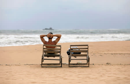 A tourist rests on a beach near hotels in a tourist area in Bentota, Sri Lanka May 2, 2019. REUTERS/Dinuka Liyanawatte