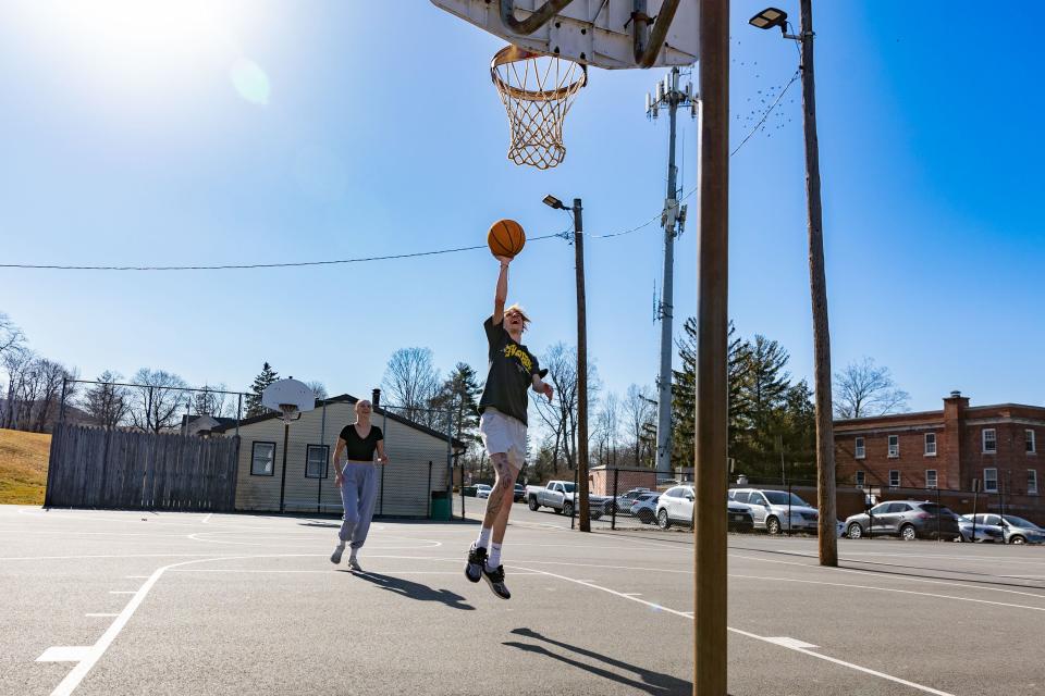 Annelie Cantu, left and Michael Decelestino, right, play basketball at the park in Cornwall, NY, on Feb. 15, 2023.
