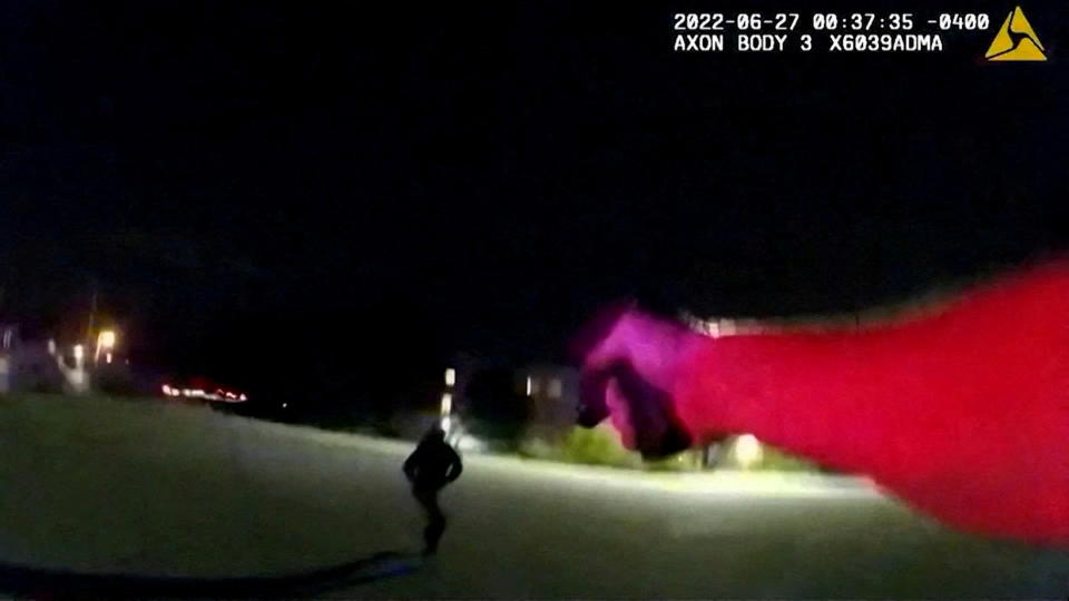 An Akron Police officer points his weapon at Jayland Walker