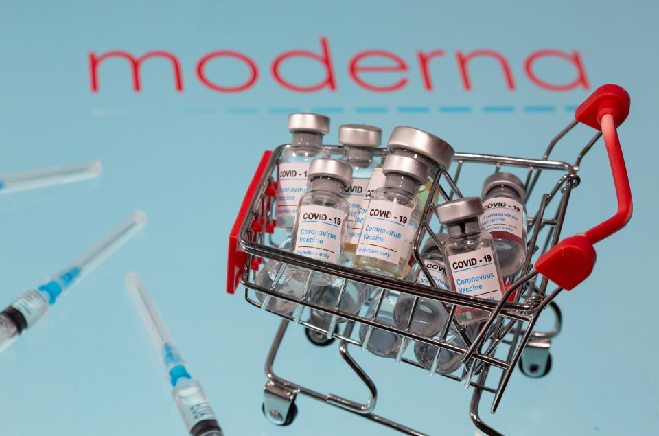 A small shopping basket filled with vials labeled "COVID-19 - Coronavirus Vaccine" and medical sryinges are placed on a Moderna logo in this illustration taken November 29, 2020. Picture taken November 29, 2020. REUTERS/Dado Ruvic/Ilustration