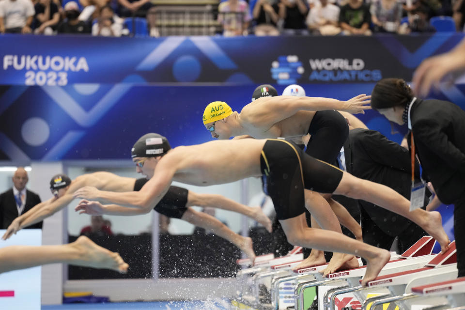 Alexander Graham of Australia, top, competes during the men's 4x200m freestyle relay final at the World Swimming Championships in Fukuoka, Japan, Friday, July 28, 2023. (AP Photo/Eugene Hoshiko)