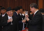 Chinese President Xi Jinping speaks with Nepalese Prime Minister Khadga Prasad Oli during a banquet at Soltee Hotel in Kathmandu, Nepal, Saturday, Oct. 12, 2019. Xi on Saturday became the first Chinese president in more than two decades to visit Nepal, where he's expected to sign agreements on some infrastructure projects. (Bikash Dware/The Rising Nepal via AP)