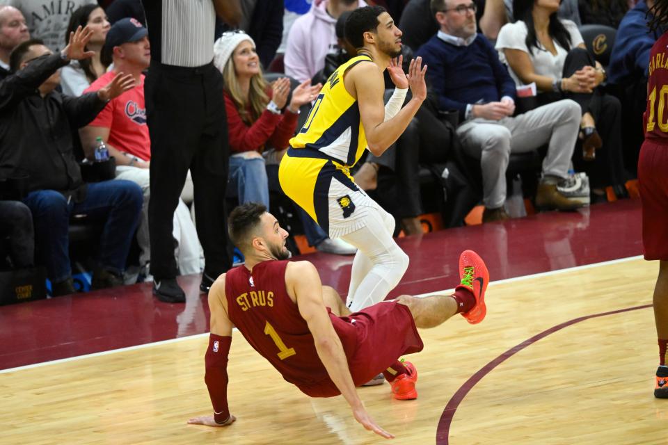 Apr 12, 2024; Cleveland, Ohio, USA; Indiana Pacers guard Tyrese Haliburton (0) reacts after he fouled Cleveland Cavaliers guard Max Strus (1) on a three-point basket attempt in the fourth quarter at Rocket Mortgage FieldHouse. Mandatory Credit: David Richard-USA TODAY Sports