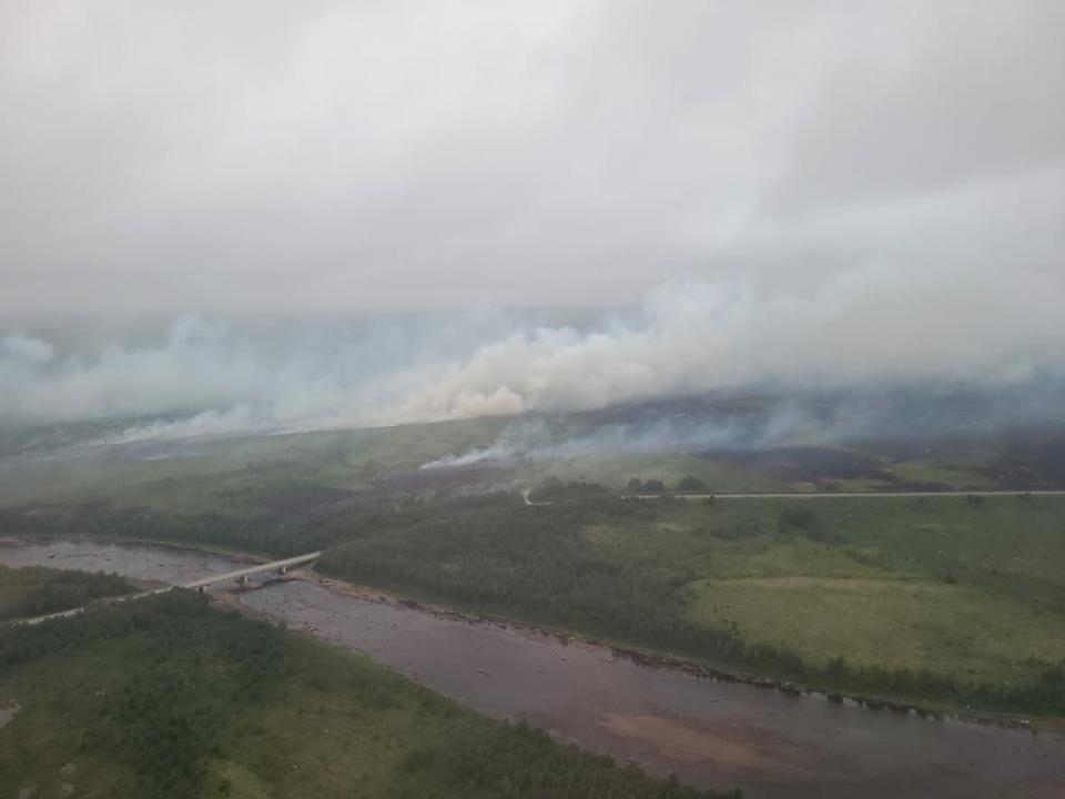 Smoke from a forest fire in central Newfoundland is shown in a government handout photo Sunday. The rapid growth of a long-burning forest fire in central Newfoundland has triggered a state of emergency in the area and prompted Premier Andrew Furey to urge some nearby communities to prepare for possible evacuation.  (Government of Newfoundland and Labrador/The Canadian Press - image credit)