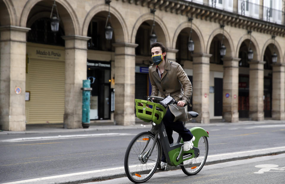 A man wearing a face mask rides a Velib bicycle in the deserted and car-free "rue de Rivoli" in Paris, France, on May 5. (Photo: Chesnot via Getty Images)