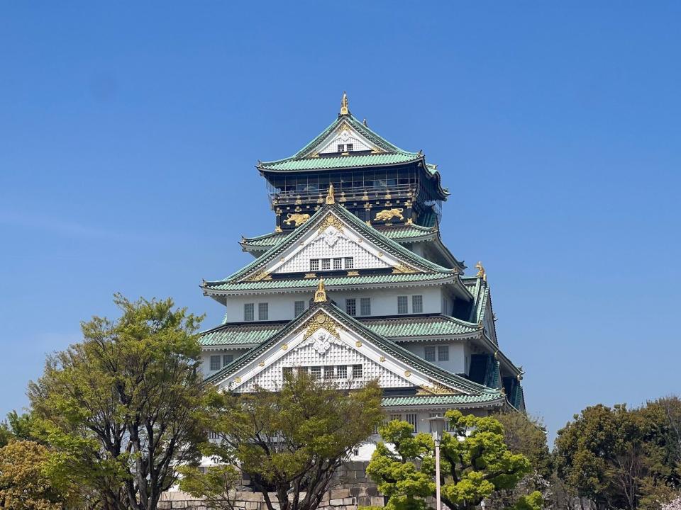 Osaka Castle with green trees.