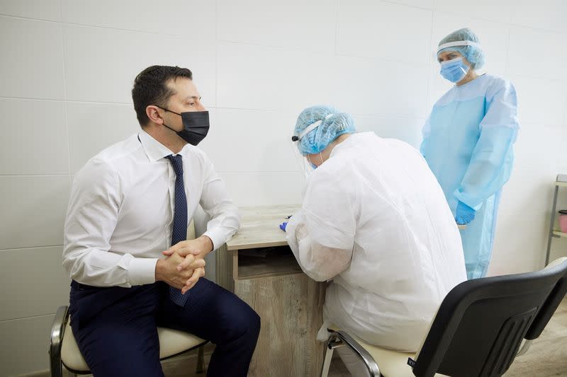 FILE PHOTO: Ukraine's President Zelenskiy waits before receiving a dose of a vaccine against the coronavirus disease in Luhansk Region