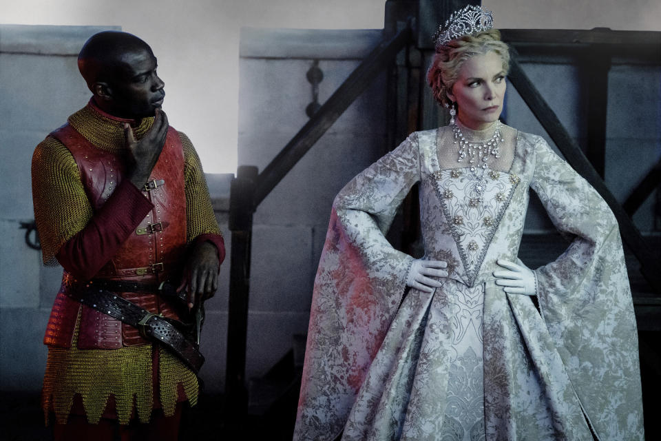 This image released by Disney shows David Gyasi, left, and Michelle Pfeiffer as Queen Ingrith in a scene from "Maleficent: Mistress of Evil." (Jaap Buitendijk/Disney via AP)