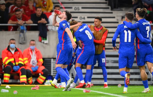 <strong>Declan Rice drinks from a cup that was thrown at Raheem Sterling after scoring their first goal.</strong> (Photo: Michael Regan via Getty Images)