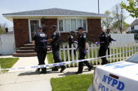 NYPD officers search house to house for the weapon used to shoot New York City plainclothes police officer Brian Moore at the Queens Village, in New York May 3, 2015. REUTERS/Eduardo Munoz