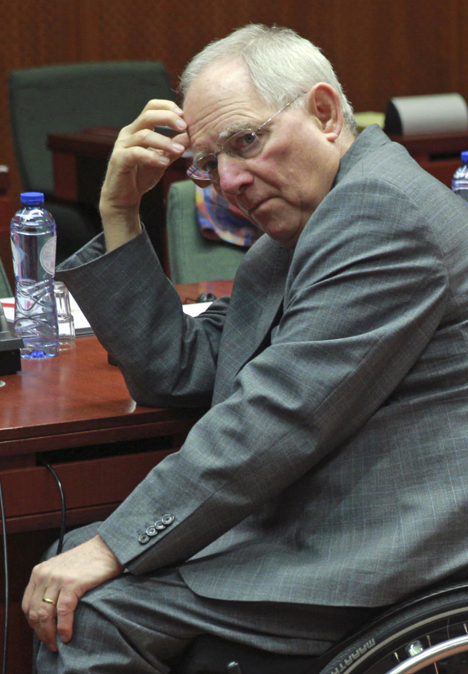 German Finance Minister Wolfgang Schaeuble waits for the start of an EU finance ministers meeting at the European Council building in Brussels, Tuesday, March 11, 2014. The Council prepares the presidency's mandate to finalize negotiations with the European Parliament on the proposal for a single resolution mechanism for banks. (AP Photo/Yves Logghe)