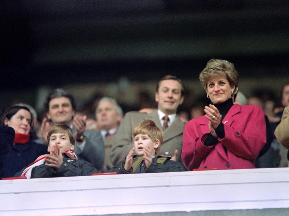 Diana, Princes William and Harry applaud during the Wales vs France Five Nations Cup match at Cardiff Arms Park on 1 February, 1992 (Jean-Pierre Muller/AFP)