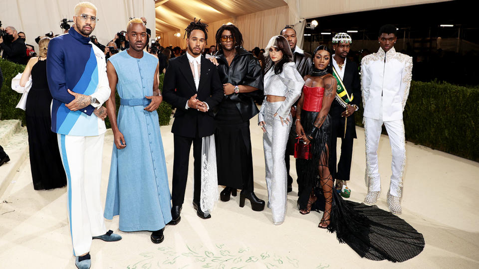 Lewis Hamilton, pictured here with a number of upcoming fashion designers at the Met Gala. 