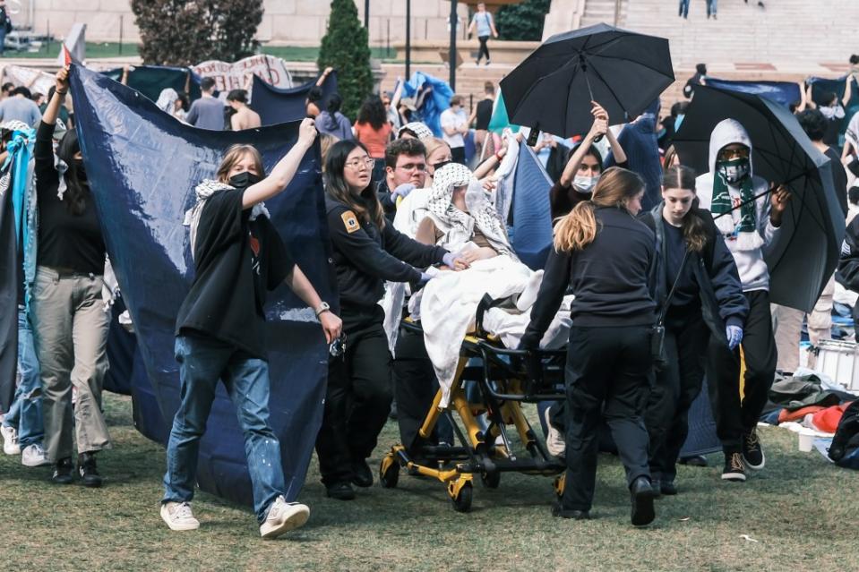 A student was taken away from the protests on a stretcher on Saturday.