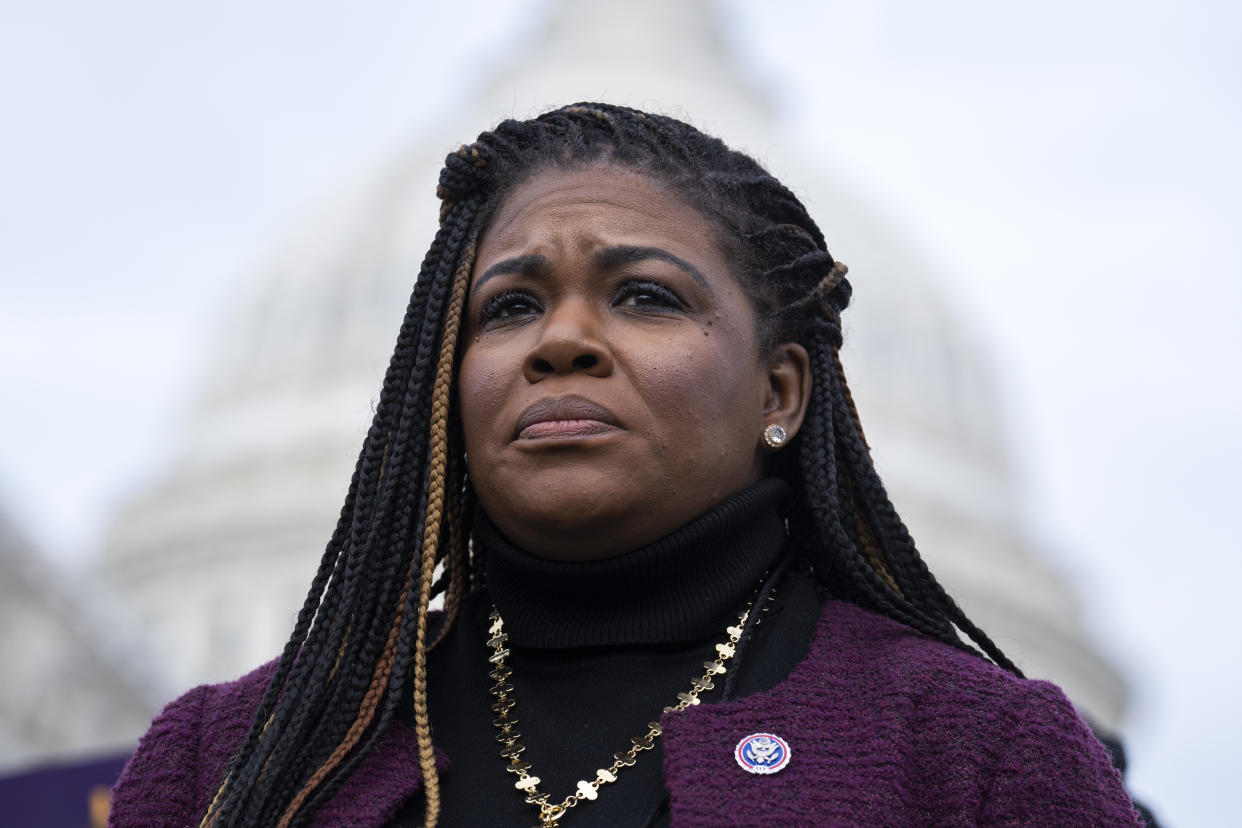 Bush looks on during a news conference, with the Capitol building behind her.