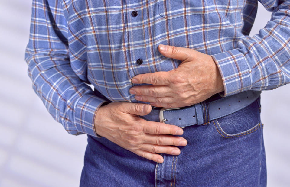 a man clutching his stomach