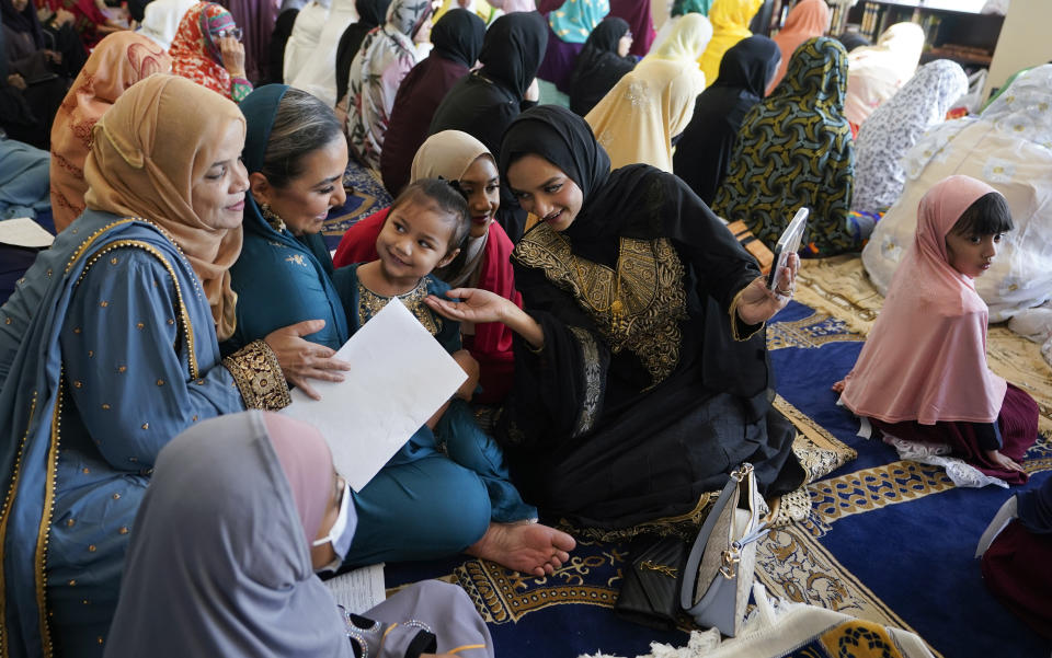 FILE - Women and children gather before Eid al-Fitr prayers, Friday, April 21, 2023, at the Muslim Community Center in Silver Spring, Md. (AP Photo/Carolyn Kaster, File)