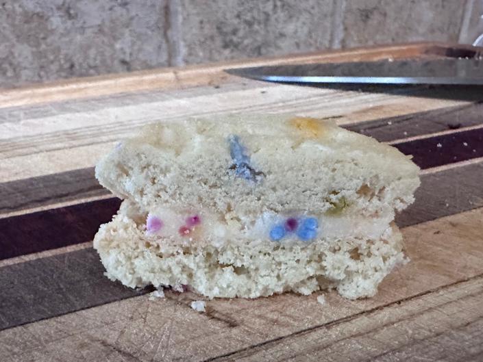 Sprinkles Walk into a Sandwich cookies cut in half