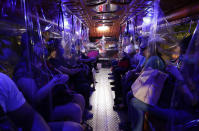 Plastic sheets on a traditional Jeepney bus separate passengers as part of health measures to help prevent the spread of the new coronavirus in metropolitan Manila, Philippines on Friday, July 3, 2020. The government is allowing some routes for Jeepneys to be opened to help public transportation as the government slowly eases the coronavirus lockdown (AP Photo/Aaron Favila)