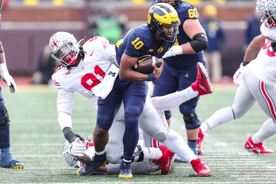 Michigan backup quarterback Alex Orji runs against the Ohio State defense during the second half at Michigan Stadium in Ann Arbor on Saturday, Nov. 25, 2023.