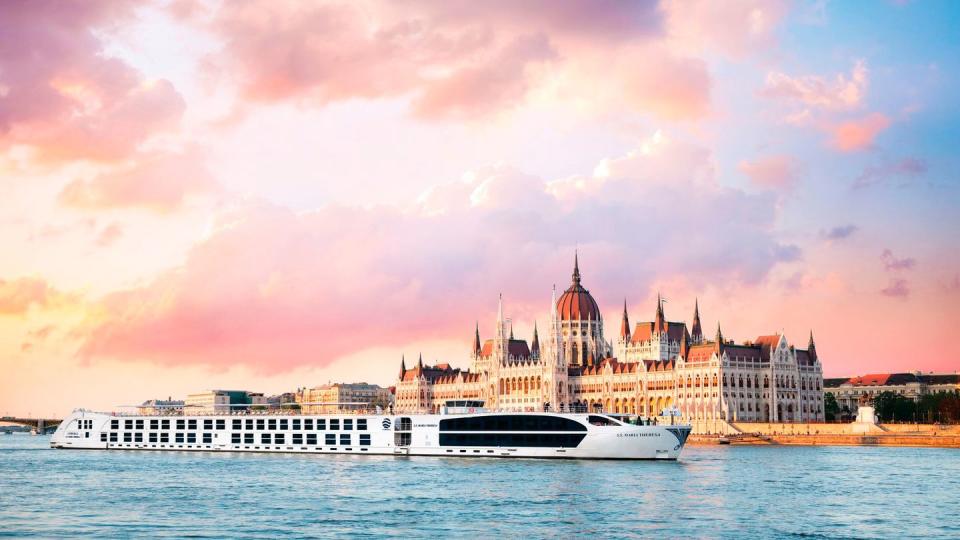 a large white boat in front of a large building