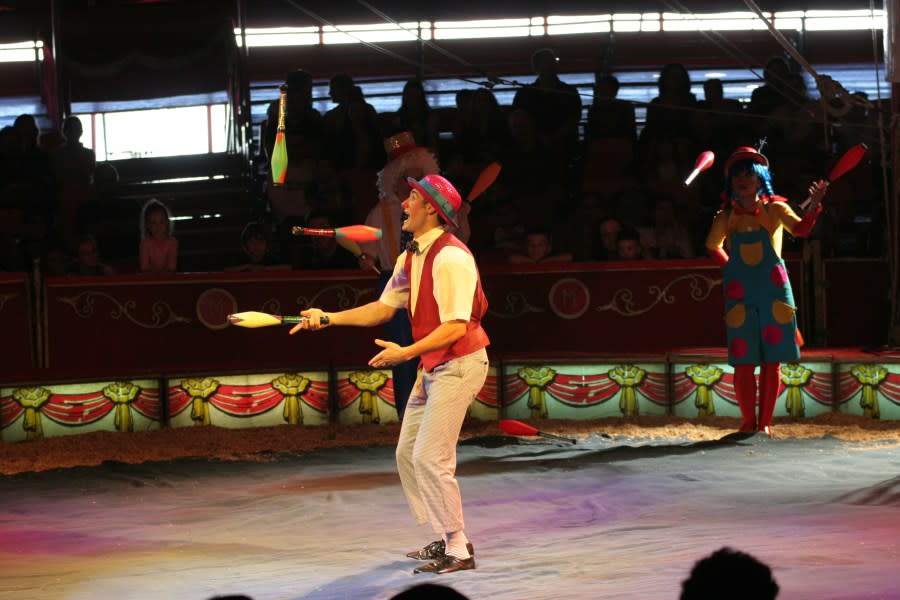 During a Circus Medrano performance, a trip of colorfully dressed jugglers performs in the ring. (Photo by Dan Porges/Getty Images)