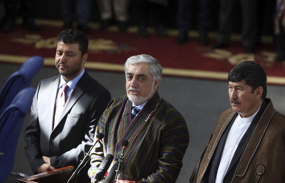 Afghanistan Chief Executive Abdullah Abdullah, center, announces his presidential candidacy along with Enayatullah Babur Farahmand, left, running for first vice president and Asadullah Sahadati, for second vice president, during a ceremony in Kabul, Afghanistan, Sunday, Jan. 20, 2019. Ghani and Chief Executive Abdullah Abdullah on Sunday registered to run for president later this year, setting up a rematch after a bitterly disputed 2014 vote led to a power-sharing agreement brokered by the United States. (AP Photo/Rahmat Gul)