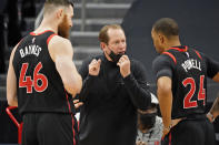 Toronto Raptors head coach Nick Nurse talks to center Aron Baynes (46) and guard Norman Powell (24) during the second half of an NBA basketball game against the Philadelphia 76ers Sunday, Feb. 21, 2021, in Tampa, Fla. (AP Photo/Chris O'Meara)