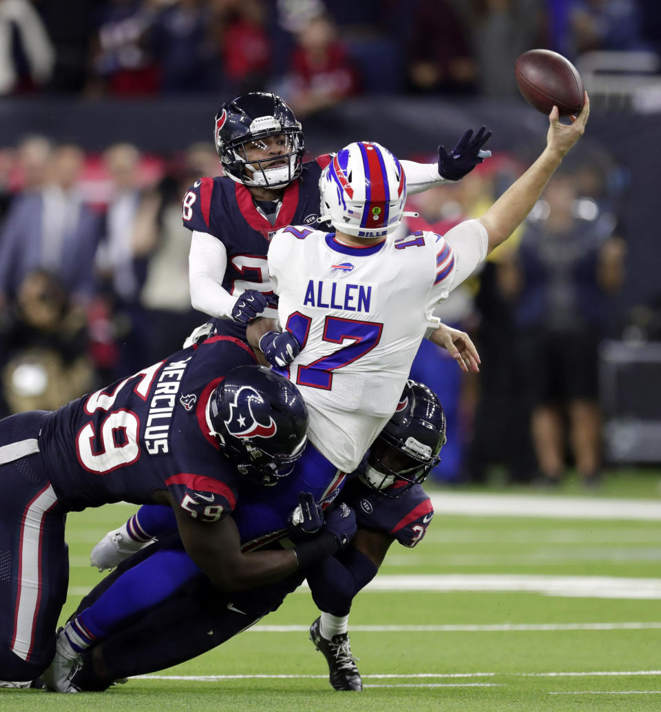 Buffalo Bills quarterback Josh Allen (17) tries to throw a pass as he is tackled by Houston Texans' Whitney Mercilus (59), A.J. Moore Jr., right, and Vernon Hargreaves III (28) during the second half of an NFL wild-card playoff football game Saturday, Jan. 4, 2020, in Houston. (AP Photo/Michael Wyke)