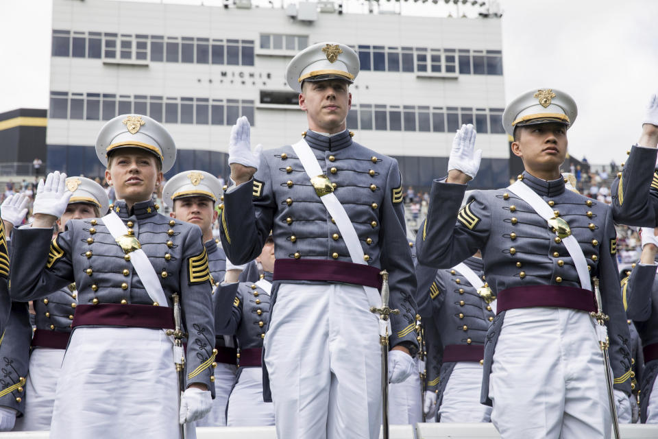 West Point cadets raise their right hands to take the oath before tossing their caps during graduation ceremonies at the United States Military Academy, Saturday, May 25, 2019, in West Point, N.Y. (AP Photo/Julius Constantine Motal)