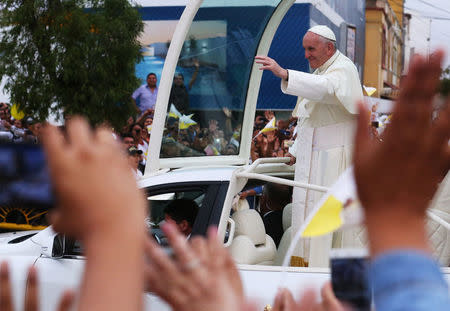 Pope Francis waves while driving past, in Lima, Peru January 18, 2018. REUTERS/Pilar Olivares