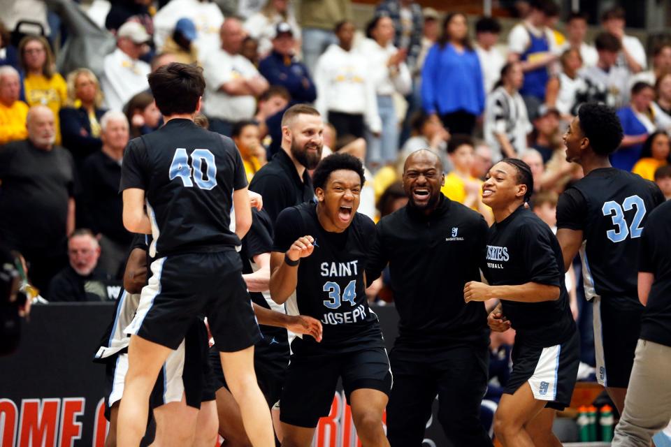 Saint Joseph starts to celebrate after beating Delta, 44-41 (3OT), in an IHSAA Class 3A boys basketball semistate championship game Saturday, March 16, 2024, at Logansport High School.