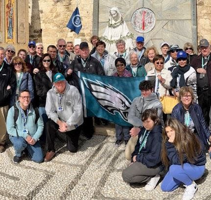 Delaware Valley Catholics pose with an Eagles banner during an ongoing tour of Israel.