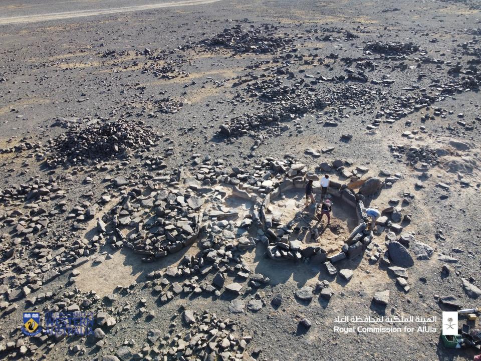 An aerial photograph showing archaeologists excavating the site