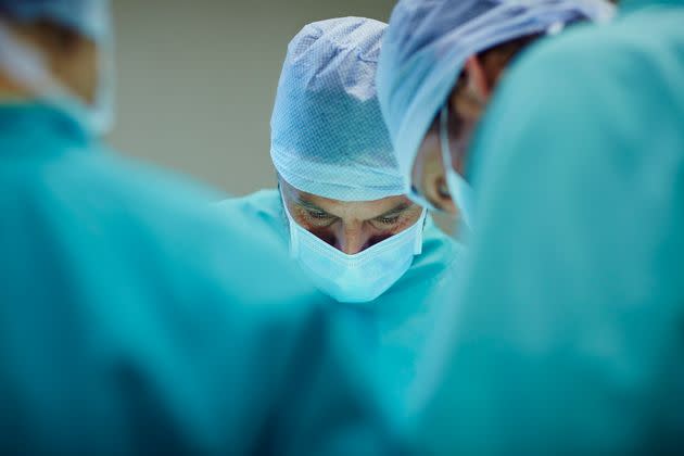 Male surgeons working in operating room at hospital (Photo: Morsa Images via Getty Images)