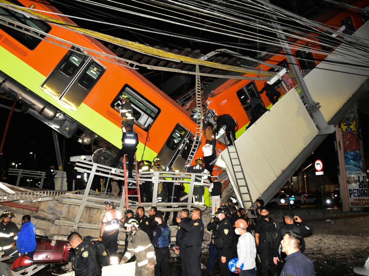 Rescue workers gather at the site of a metro train accident after an overpass for a metro partially collapsed in Mexico City on May 3, 2021. (AFP via Getty Images)