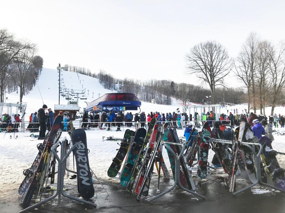 Skiers and snowboarders line up at the Mountain Express chairlift at Boyne Mountain on Sunday, Jan. 15, 2023.