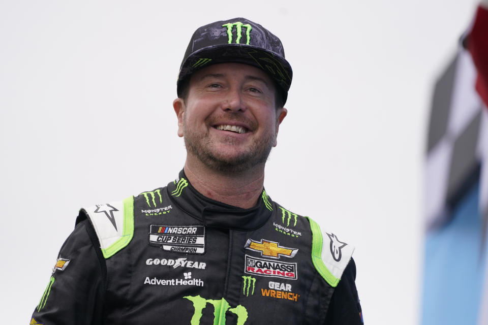 FILE - In this July 18, 2021, file photo, Kurt Busch smiles at a NASCAR Cup Series auto race in Loudon, N.H. Busch will drive next season for 23XI Racing, the NASCAR team owned by Denny Hamlin and Michael Jordan, in a long expected expansion move for the first-year organization. (AP Photo/Charles Krupa, File)