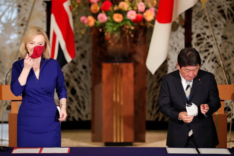 Britain's International Trade Secretary Elizabeth Truss and Japanese Foreign Minister Toshimitsu Motegi sign the UK-Japan Comprehensive Economic Partnership Agreement in Tokyo