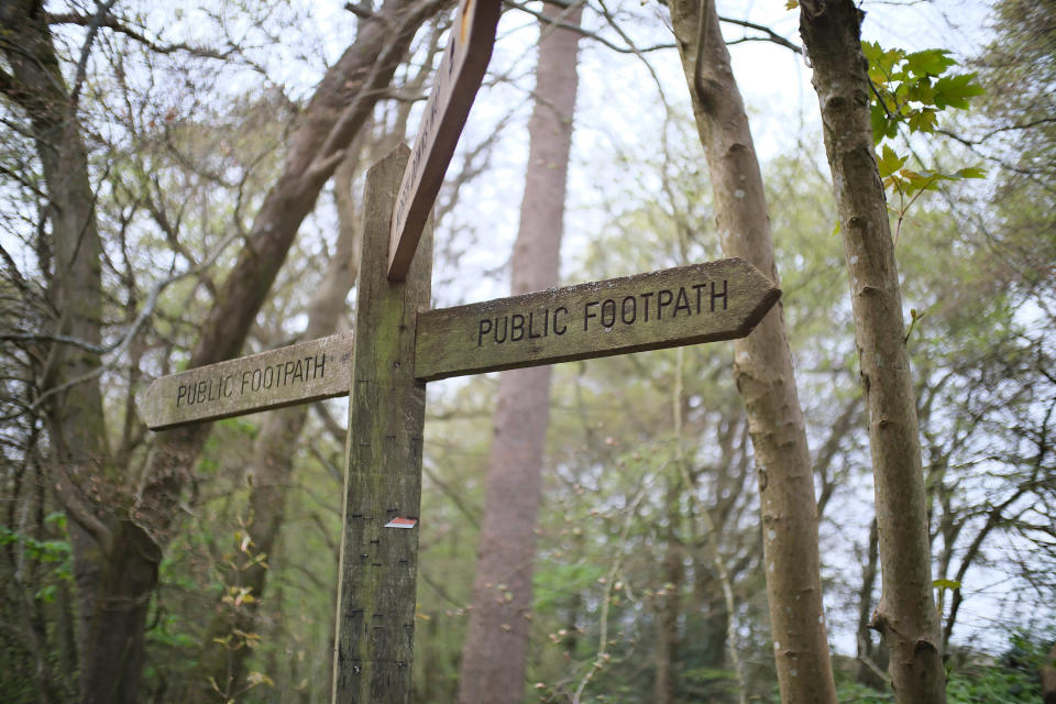 A signpost in a field photographed with the TTArtisan 25mm F/2 lens for Fujifilm X mirrorless cameras