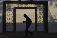 A Health Ministry worker enters a government facility where COVID-19 vaccines are stored in San Salvador, El Salvador, Thursday, May 13, 2021. (AP Photo/Salvador Melendez)